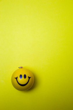 Photo of a yellow smiley face on yellow background