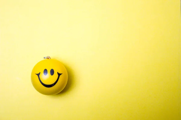 Photo of a yellow smiley face on yellow background