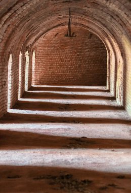 Photo of a room with archways inside a building, light and shadow