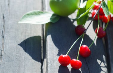                                There are pears, cherries, apples, various fruits on the table
