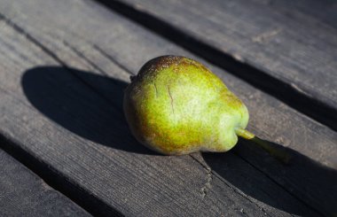                           There is a pear on the table, a green pear     