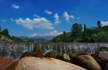                                There is a stone dam on the water's edge
