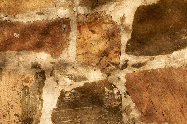 Un vieux mur de pierres de granit de différentes tailles comme fond. — Photo