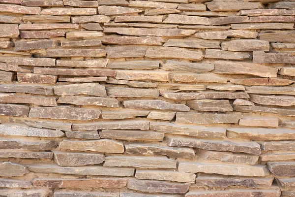 A wall of carved stones as a background. — Fotografia de Stock