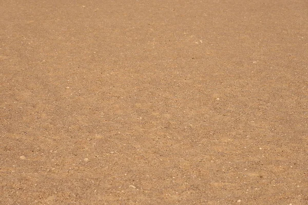 Sand in der Sonne in der Wüste als Kulisse. — Stockfoto