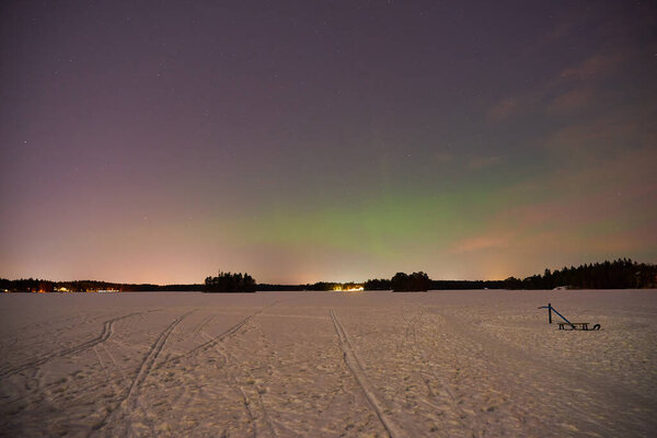 The Northern Lights on a lake in Finland.