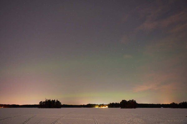 The Northern Lights on a lake in Finland.