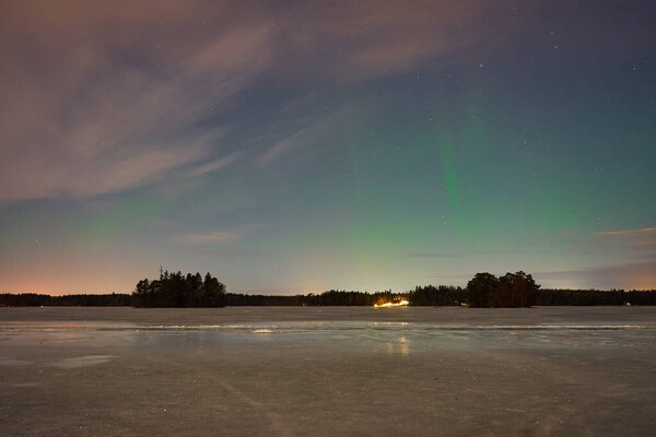 The Northern Lights on a lake in Finland.