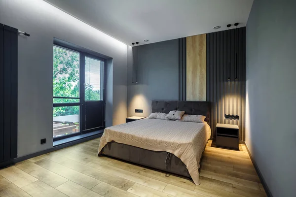 Modern and loft bedroom with dark and grey style Dark headboard and wooden floor with glass window.