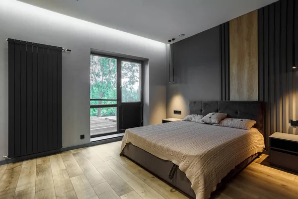 Modern and loft bedroom with dark and grey style Dark headboard and wooden floor with glass window.