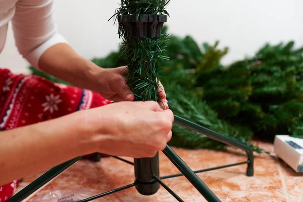 Close up shoot of an unrecognizable woman assembling christmas tree — Stock Photo, Image