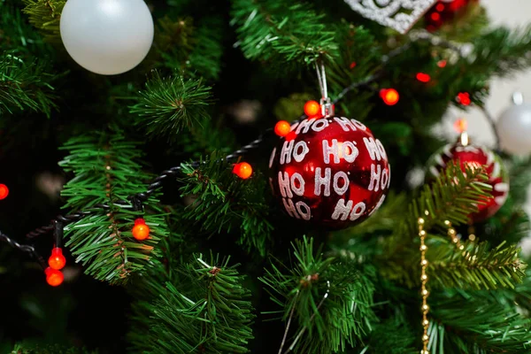 Traditional artificial Christmas tree with red ball ornament with glowing lights — Stock Photo, Image