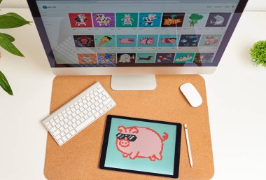 NFT on a digital tablet on a desk illustration of a pig clipart