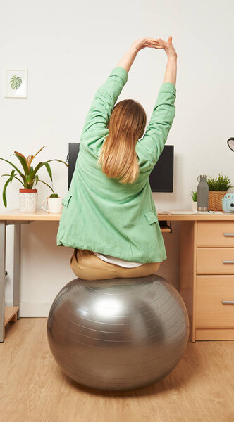 Woman stretching while working from home remotely