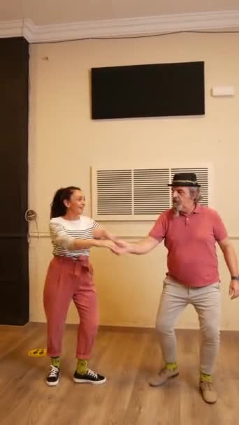 A senior adult couple dancing Lindy Hop in a studio — ストック動画