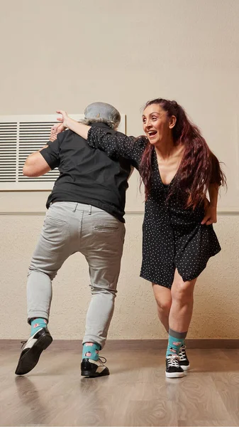 Senior adult couple dancing lindy hop in a ballroom Stock Image