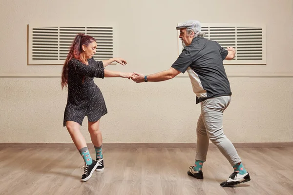 Dance couple doing a lindy hop dance move Stock Image