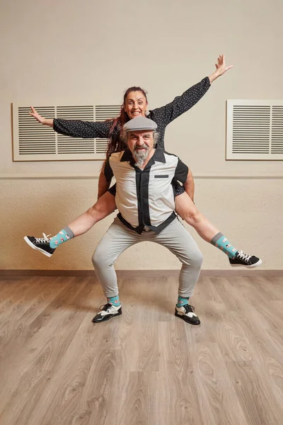 Senior adult couple dancing lindy hop in a ballroom Royalty Free Stock Photos