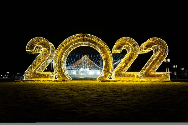 Happy New Year 2022. Sparkling burning numbers Year 2022 with on black background. Beautiful design element. christmas street decorations