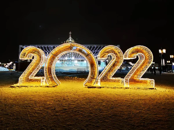 Happy New Year 2022. Sparkling burning numbers Year 2022 with on black background. Beautiful design element. christmas street decorations