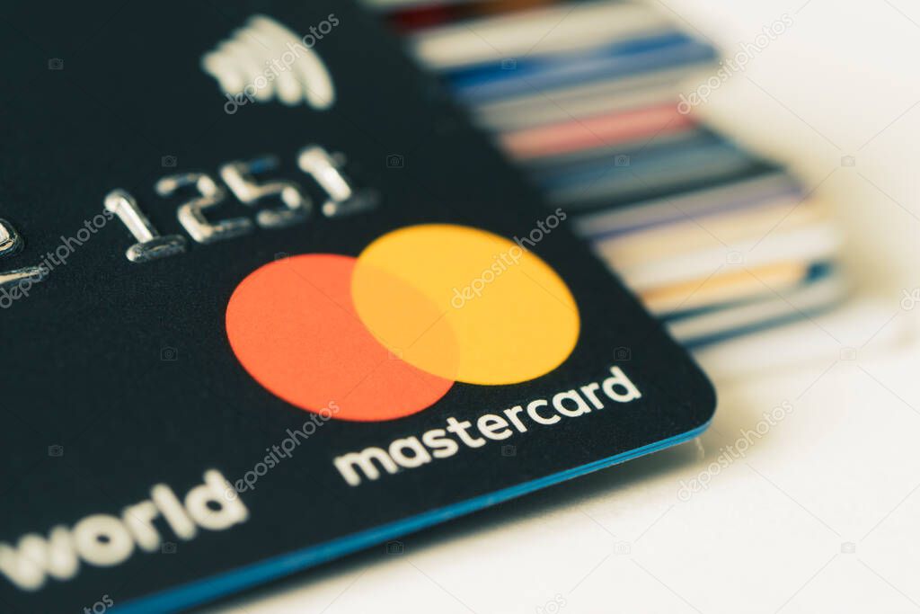 Gold bitcoin symbol and credit card master cards on the table. February 20, 2021, Barnaul, Russia