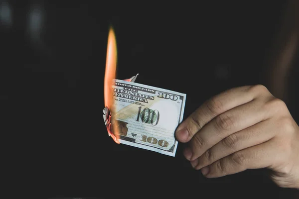 Hands and burnning money - business concept. concept of inflation. abandoning the dollar