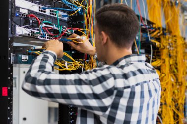 Genç adam ethernet şalterinde çalışıyor. Yüksek kalite fotoğraf