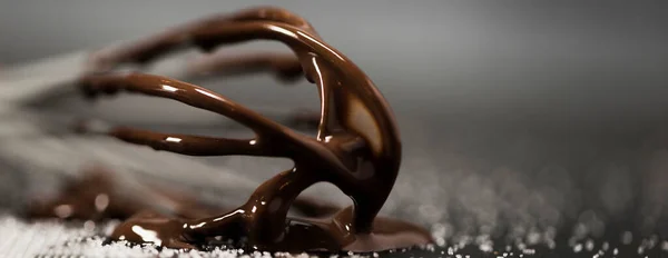 Close up whisk with melted chocolate sugar — Stock Photo, Image