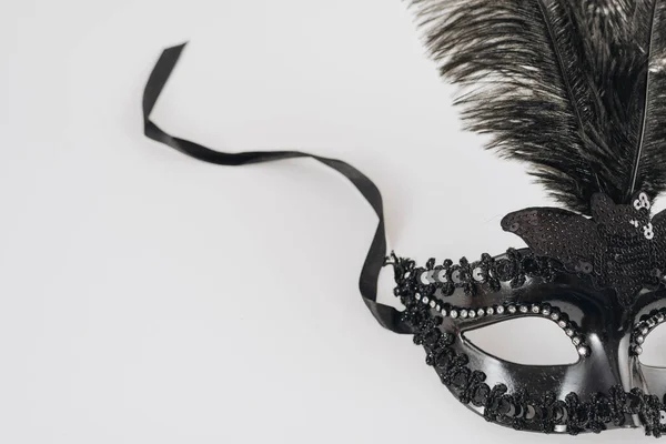 Black carnival mask with feather table. High quality photo — Stock Photo, Image