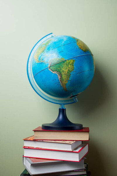 stacked books with globe. High quality photo