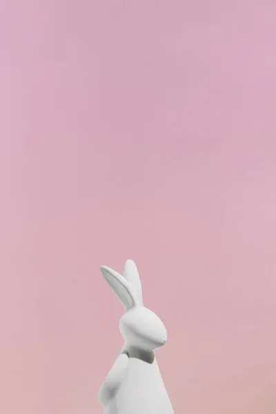 Bílá králičí figurka růžové pozadí. Kvalitní fotografie — Stock fotografie