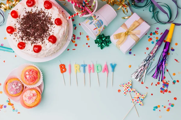 Palabra cumpleaños velas partido accesorios pastel telón de fondo azul. Foto de alta calidad — Foto de Stock