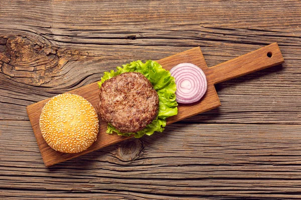 flat lay burger ingredients cutting board. High quality photo