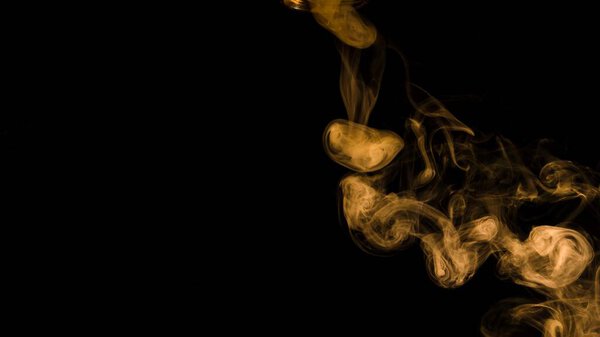 Yellow smoke curl black background with copy space writing text. High resolution photo