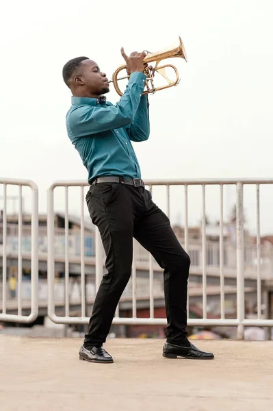 young man playing music jazz day. High resolution photo