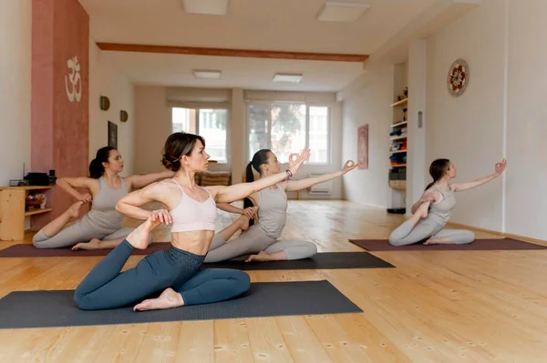 yoga teacher teaching class 6. High resolution photo