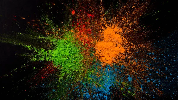 splatted green blue orange color black background. High resolution photo