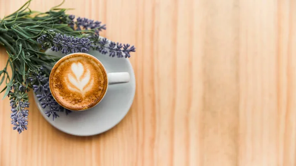 coffee latte with lavender flower wooden surface. High resolution photo