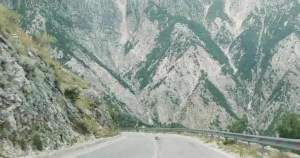 Arabanın ön camından dağlardaki yol manzarası. Kör dönüş, ters şeritte araba. Yılanlar, tehlikeli yollar, sollama yasaktır. Bir kaza olma olasılığı. — Stok video