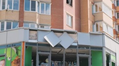 Irpin, April 2022, destroyed premises for commerce on the basement floor of a residential building, burnt out windows of the apartment from shells. War in Ukraine, consequences of shelling and