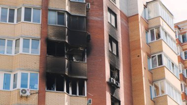 Irpin, Ukraine, April 2022, destroyed premises for commerce on the basement floor of a residential building, burnt out windows of the apartment from shells. War in Ukraine, consequences of shelling
