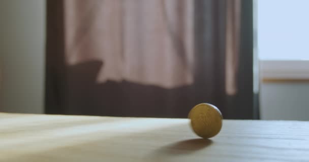 Yellow Coin Rotates Wooden Surface Table Casting Shadow Concept Circulation — Stockvideo