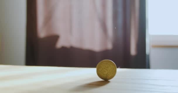 Yellow Coin Rotates Wooden Surface Table Casting Shadow Concept Circulation — Stock Video