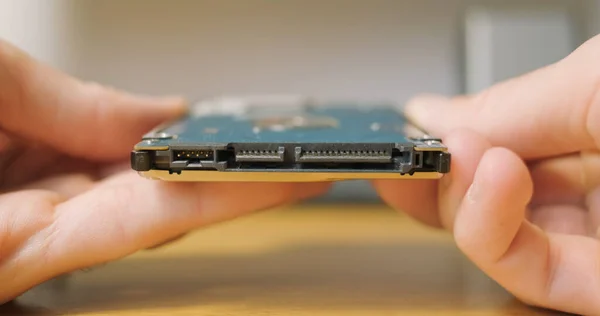 Mans hand connects sata control board to hard drive for an external drive pocket. Close-up. High quality 4k footage