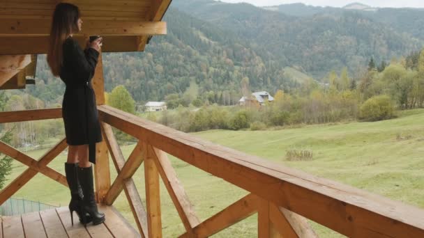 Stylish Woman Black Coat Boots Stands Wooden Balcony Hotel Terrace — Wideo stockowe