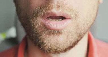 Face of an unshaven man exhales air through his mouth. Close-up, portrait, unrecognizable. Calm concept, breathing practice, nerves, health, relaxation. High quality 4k footage