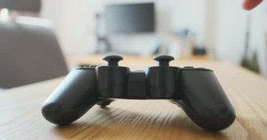 Smooth transition camera focus from one end of gamepad to the other. The joystick is on the table. Close-up. High quality 4k footage