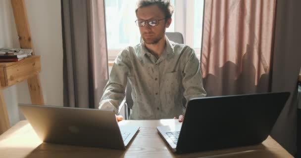 Young Man Working Two Laptops Communicates Video Call Front View — Video Stock