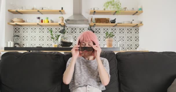 Cosplay Girl Pink Hair Puts Glasses Enters Virtual Reality Smiling — ストック動画