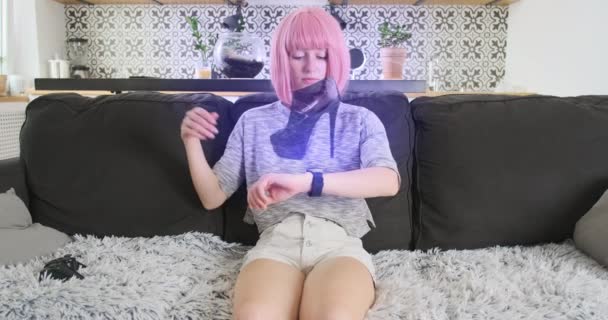 Woman Sits Sofa Chooses Shoes Hologram Watch Bracelet Concept Futuristic — ストック動画